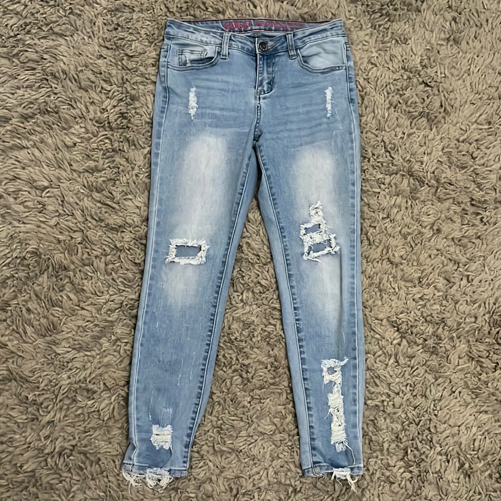 GOGO jeans mid rise to ankle, more lighter blue with rips at knees and ankles.